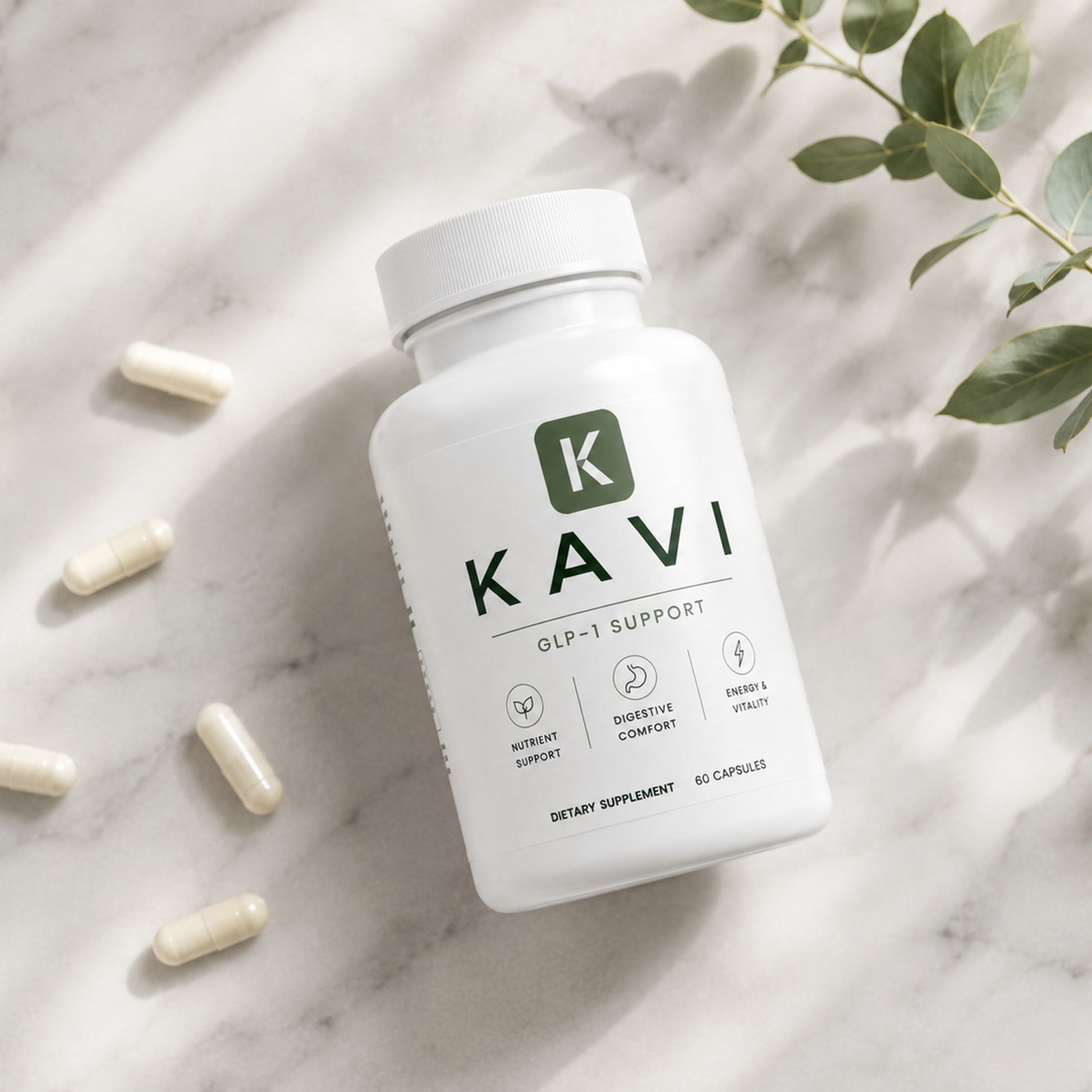 Kavi GLP-1 Support bottle flat-lay on marble with capsules and eucalyptus